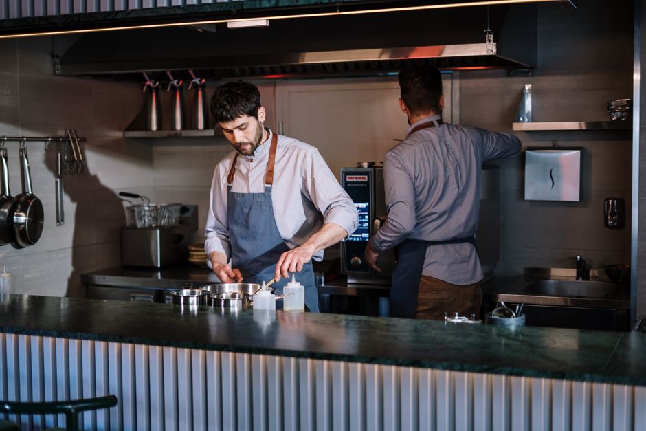 Professional restaurant kitchen team executing service with precision
