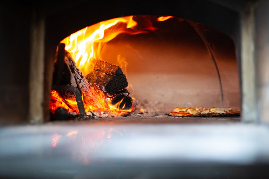 Wood-fired pizza oven with authentic Italian pizza preparation techniques